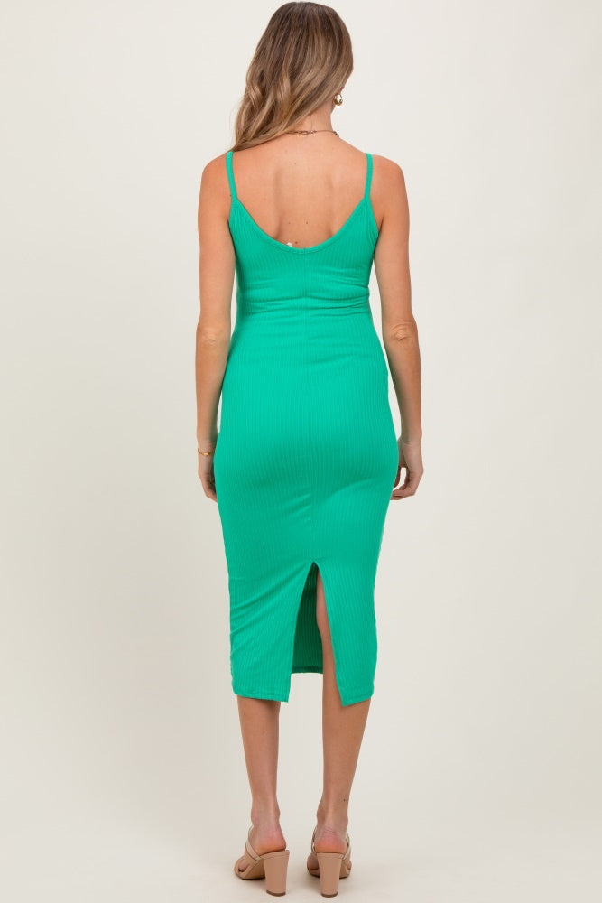 woman wearing a green ribbed midi maternity dress with a back slit and adjustable straps