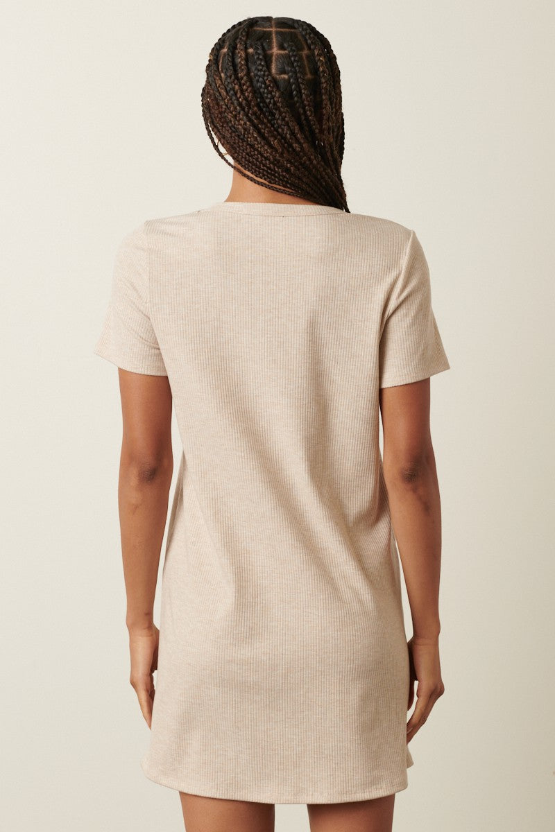 woman wearing a beige short sleeve ribbed dress seen from the back