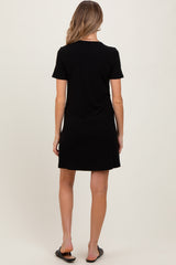 woman wearing a black short sleeve maternity dress, shown from the back