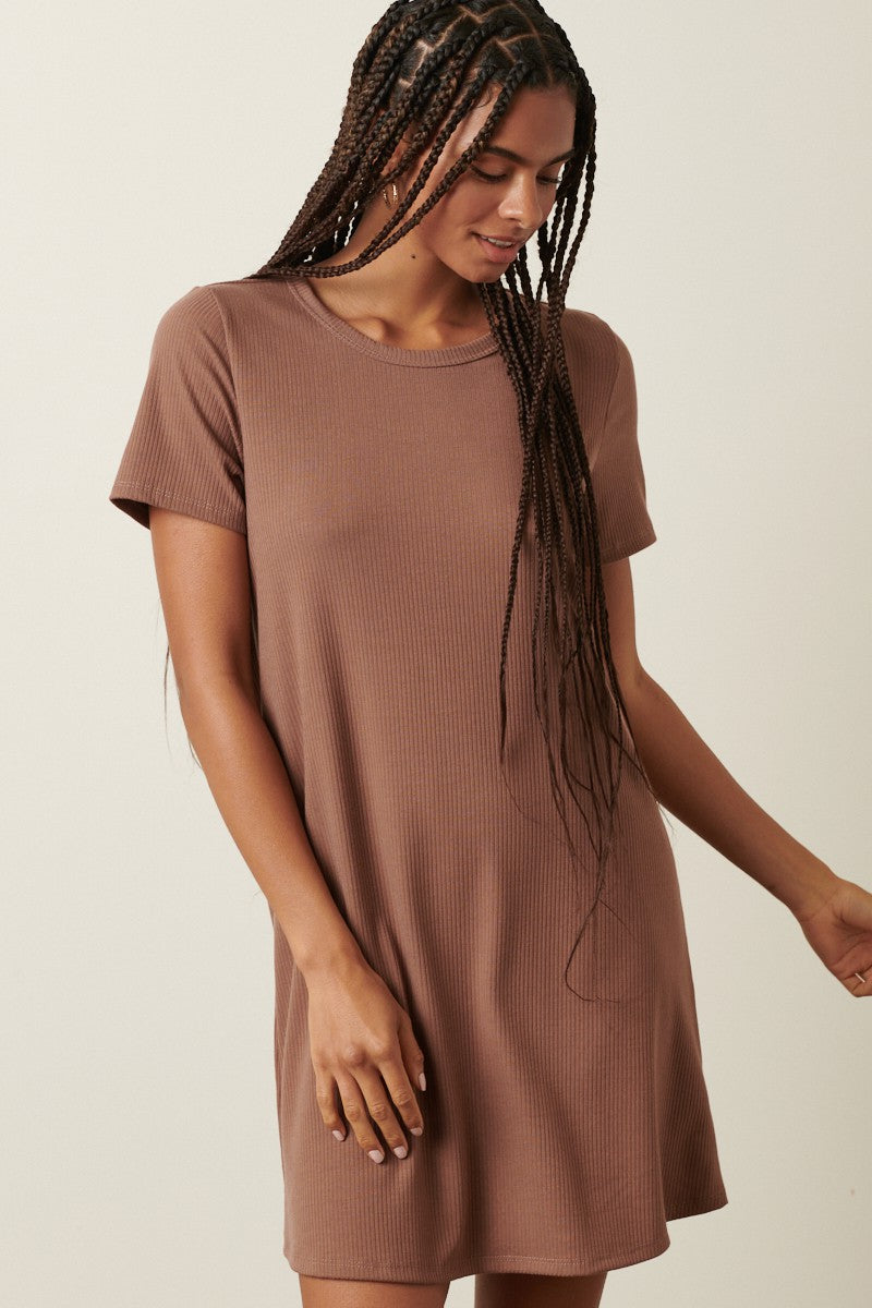 woman wearing a chocolate brown short sleeve ribbed dress with a relaxed fit and a round neckline