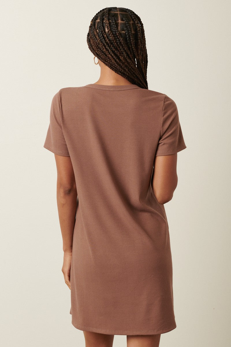 woman wearing a brown ribbed short sleeve dress, seen from the back