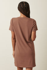 woman wearing a brown ribbed short sleeve dress, seen from the back