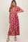 woman wearing a red floral print maternity maxi dress with short sleeves and a tie waist, showing her baby bump
