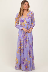 woman wearing a lavender floral long sleeve maxi dress with a wrap style and a belted waist