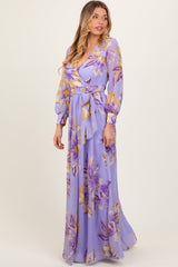 woman wearing a lavender floral maxi dress with long sleeves and a tie waist detail