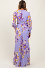 woman wearing a lavender maxi dress with large yellow and purple floral print and long sleeves, shown from the back