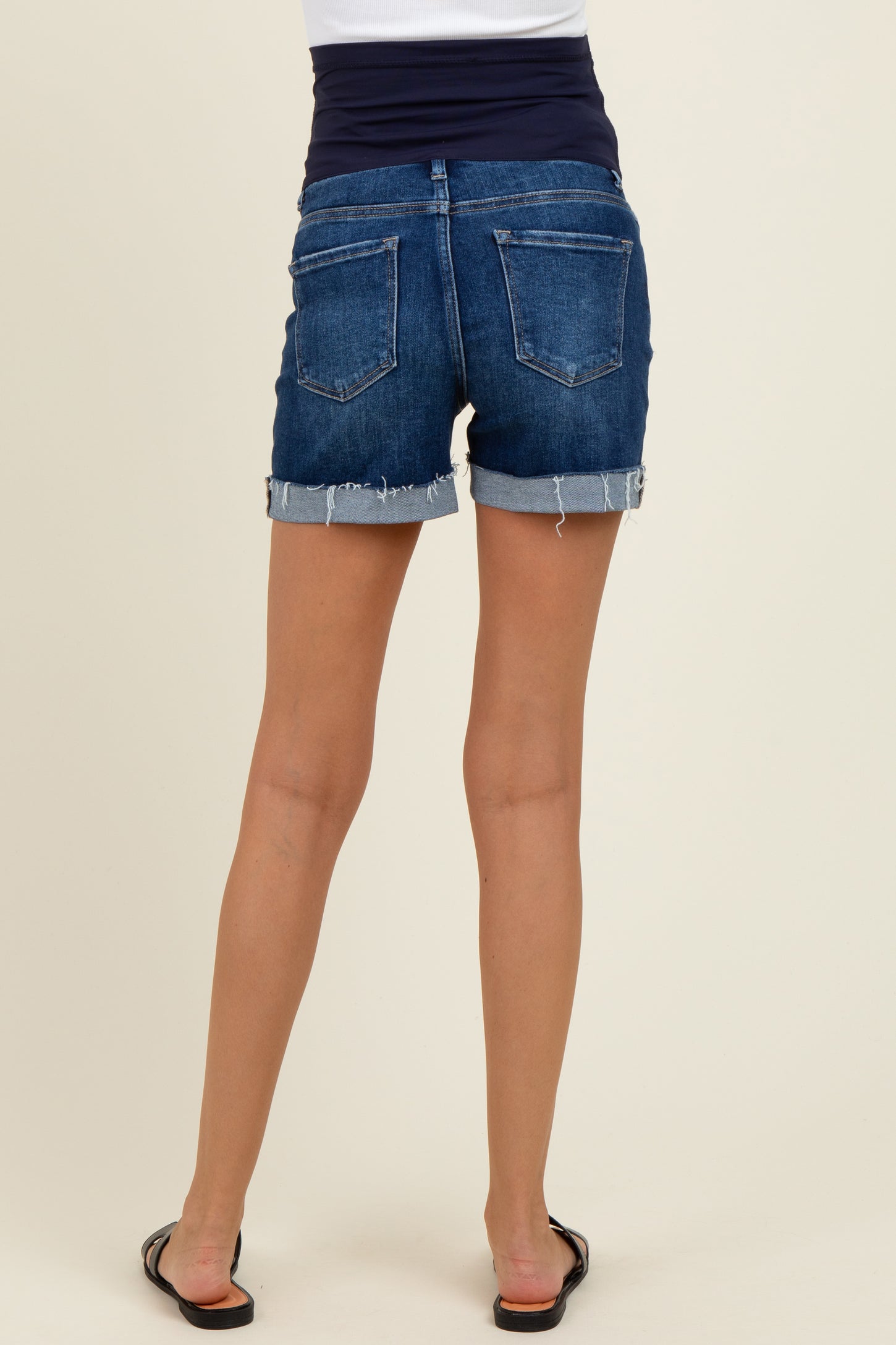 woman wearing blue denim maternity shorts with a rolled hem and a comfortable waistband