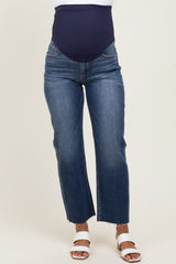 woman wearing a dark blue pair of maternity jeans with a high waist and straight leg, styled with white sandals