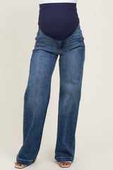 woman wearing a pair of dark blue maternity jeans with a stretchy navy belly panel