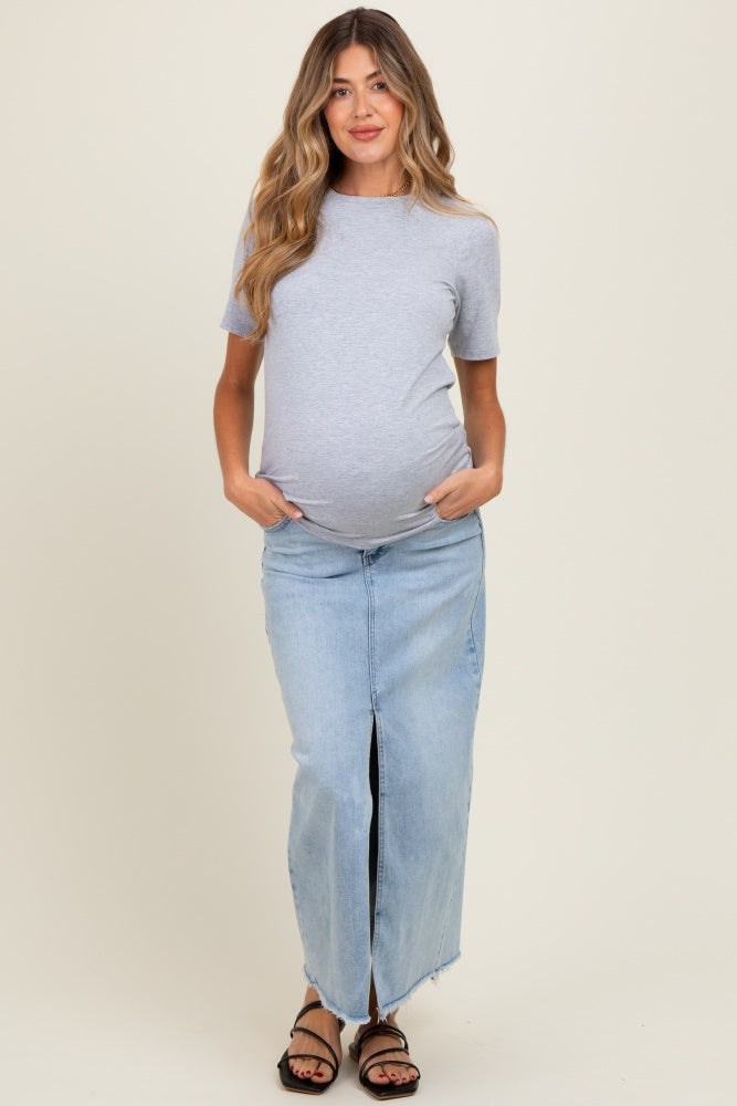 woman wearing a gray short sleeve maternity top with a pregnant belly and a blue denim maxi skirt