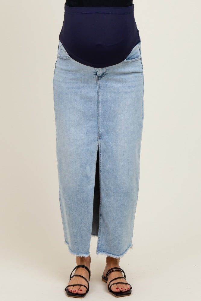 woman wearing a light wash denim maternity skirt with a front slit and a supportive belly band