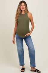 woman wearing a dark green ribbed maternity tank top and blue relaxed fit jeans, showing her baby bump