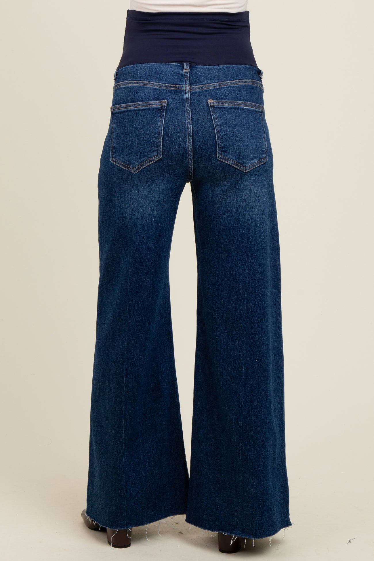 woman wearing a dark wash wide-leg maternity jeans with a comfortable waistband and no visible baby bump