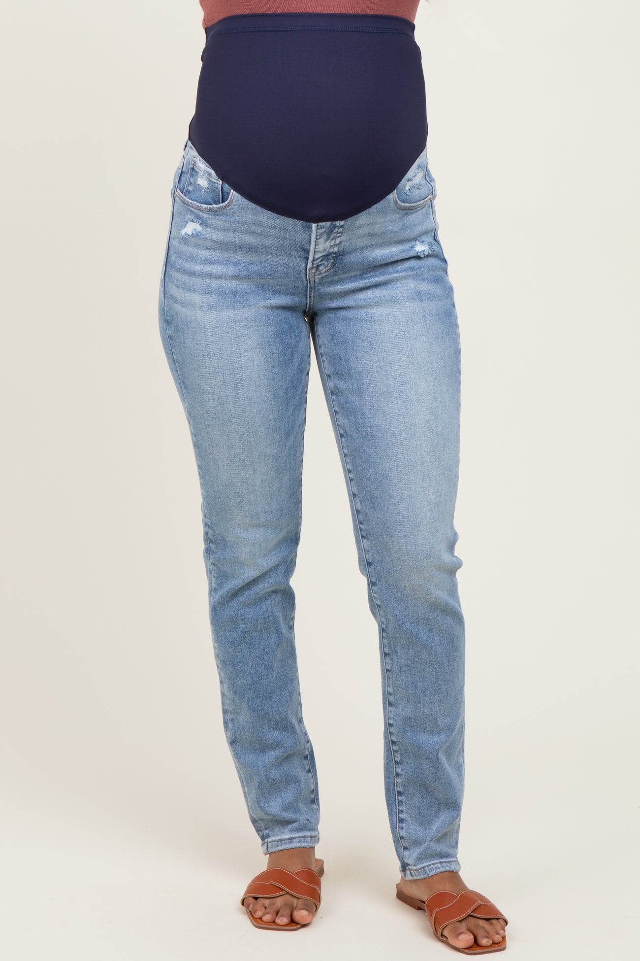 woman wearing maternity blue skinny jeans with a navy over-the-bump panel