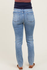 maternity wear light blue skinny jeans shown from the back, featuring a classic five-pocket design