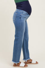 woman wearing maternity light wash high-rise jeans with frayed hem and a visible baby bump