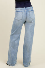 woman wearing light blue wide-leg maternity jeans, showcasing the back view