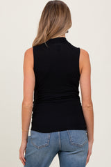 woman wearing a black sleeveless maternity top, shown from the back, paired with light blue jeans
