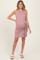 woman wearing a red and white striped maternity dress with a side tie and a visible baby bump