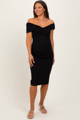woman wearing a black off-shoulder bodycon maternity dress highlighting her baby bump