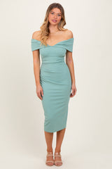 woman wearing a teal off-the-shoulder midi dress with a fitted silhouette and a sweetheart neckline