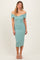 woman wearing a teal off-the-shoulder midi dress with a fitted silhouette and a sweetheart neckline