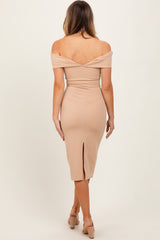 woman wearing a beige off-the-shoulder bodycon dress with a back slit, showing her bare back