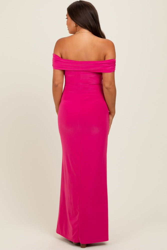 woman wearing a hot pink off-the-shoulder maternity gown with fitted bodice and long skirt, seen from the back