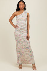 woman wearing a one-shoulder pastel printed maxi dress with ruching details and posing confidently