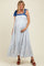 woman wearing a blue and white patterned maternity dress with tie straps and a visible baby bump