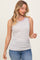 woman wearing a light purple ribbed tank top with contrasting trim and blue jeans