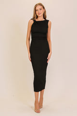 woman wearing a black ribbed midi dress with a fitted silhouette and one shoulder detail