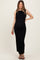 woman wearing a black sleeveless maternity maxi dress with a fitted silhouette and visible baby bump