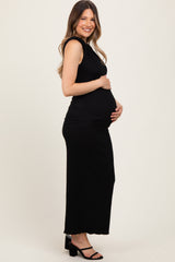 woman wearing a black ribbed maternity dress with a fitted silhouette and baby bump visible