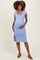 woman wearing a light blue ribbed maternity dress with a side slit, gently holding her baby bump