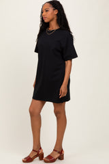 woman wearing a black oversized t-shirt dress with short sleeves and brown chunky heeled sandals