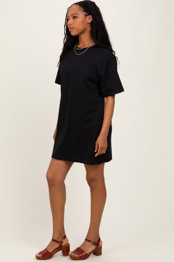 woman wearing a black oversized t-shirt dress with short sleeves and brown chunky heeled sandals