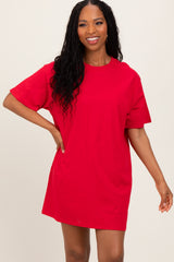 woman wearing a red oversized t-shirt dress with short sleeves and a relaxed fit