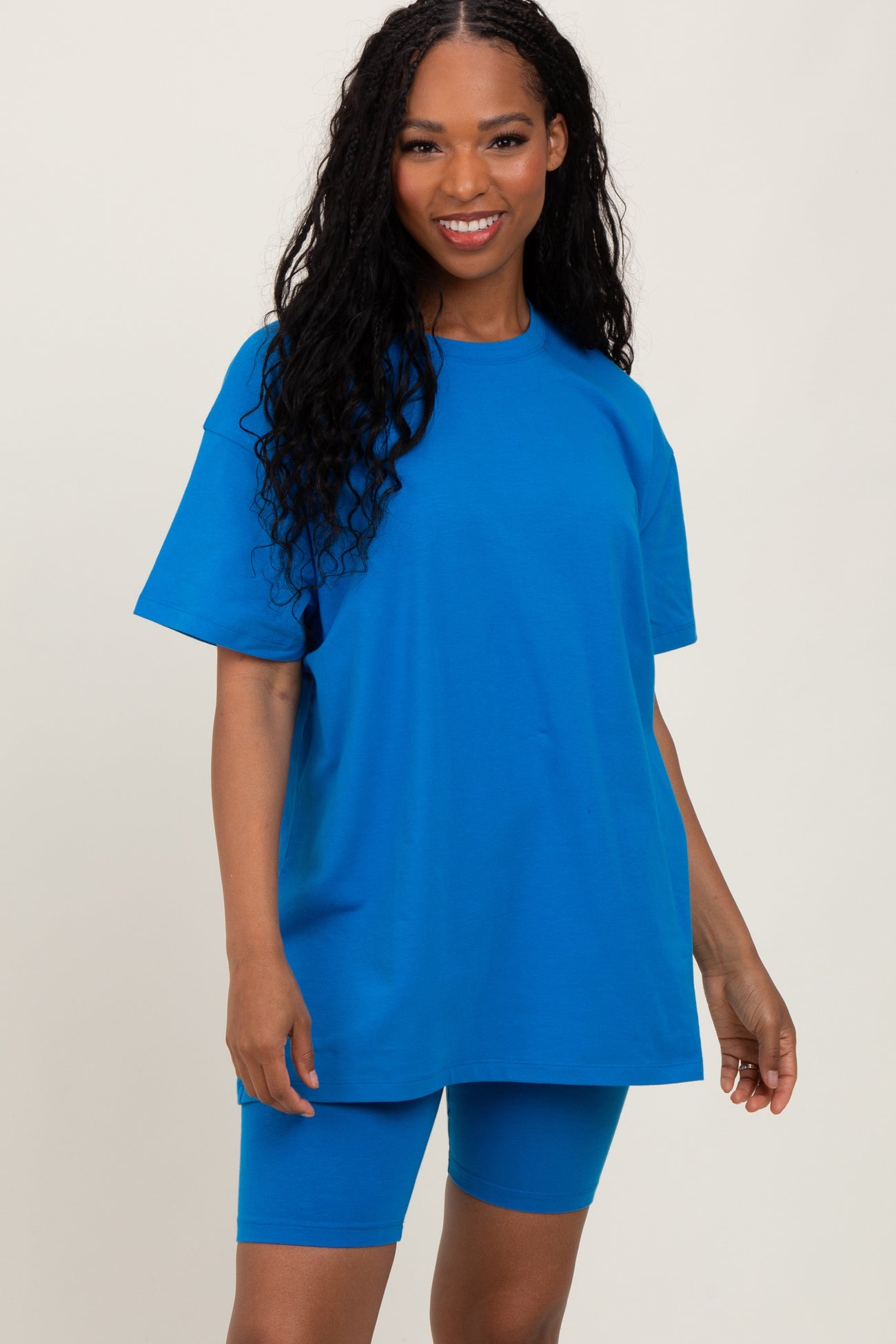 woman wearing a bright blue oversized t-shirt and matching bike shorts