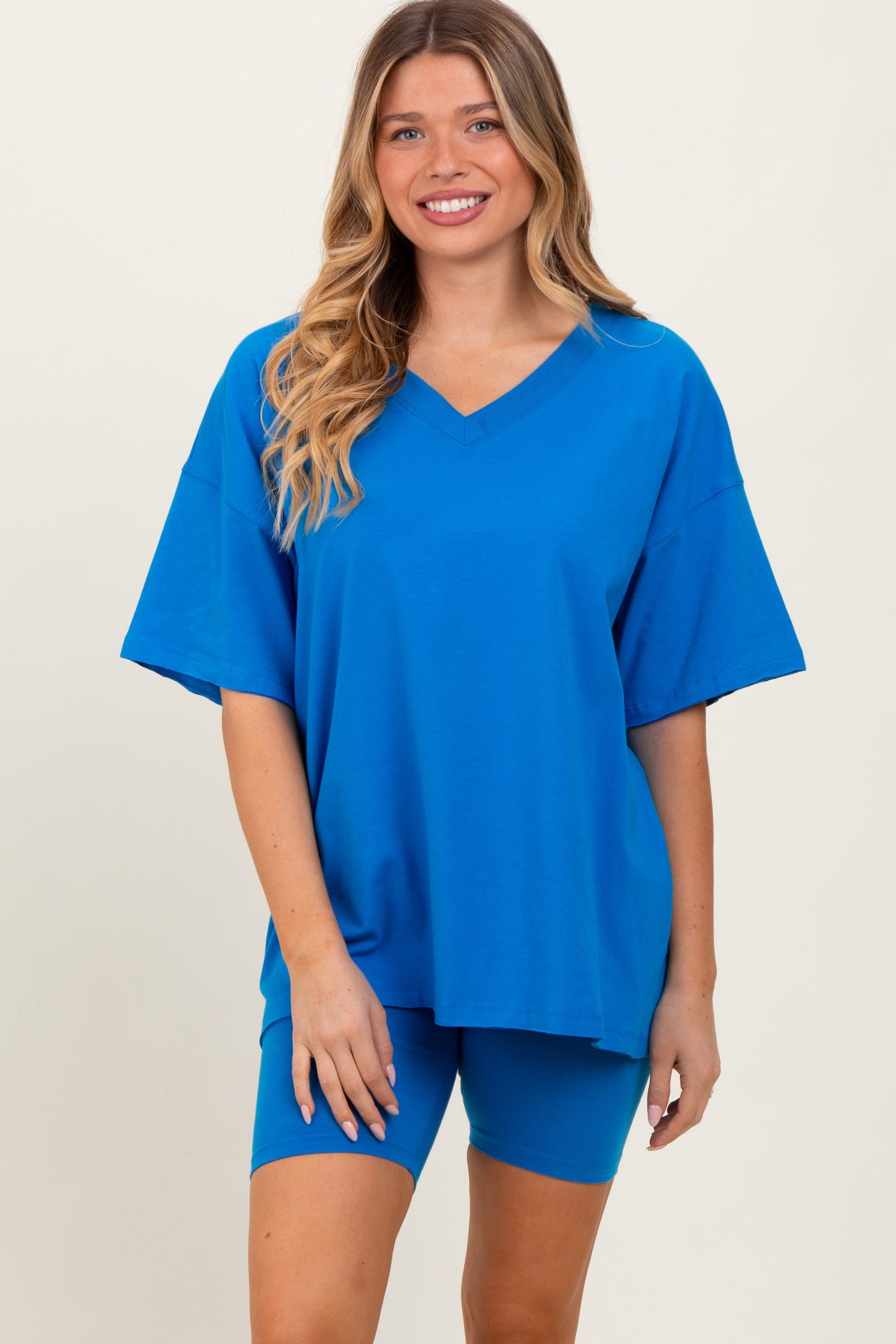 woman wearing a bright blue oversized v-neck t-shirt and matching bike shorts