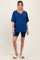 woman wearing a navy blue maternity oversized v-neck t-shirt and matching bike shorts with casual sandals