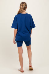 woman wearing a navy blue oversized t-shirt and matching bike shorts, maternity wear