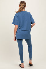 woman wearing a blue oversized t-shirt and matching leggings, maternity wear, showing a casual outfit