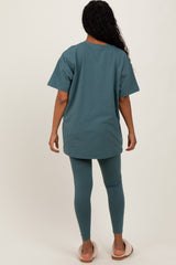 woman wearing a teal oversized t-shirt and matching leggings, seen from the back