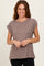 woman wearing a taupe short sleeve t-shirt with rolled sleeves and a relaxed fit