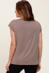 woman wearing a taupe short sleeve top viewed from the back with a relaxed fit and round neckline