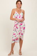 woman wearing a multicolored floral print midi dress with ruching and spaghetti straps