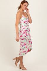 woman wearing a multicolored floral print bodycon dress with ruching and a knee-length hemline