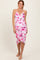 woman wearing a pink and white floral print spaghetti strap dress with a gathered detail at the waist
