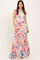woman wearing a colorful floral maxi dress with a fitted top and flared skirt